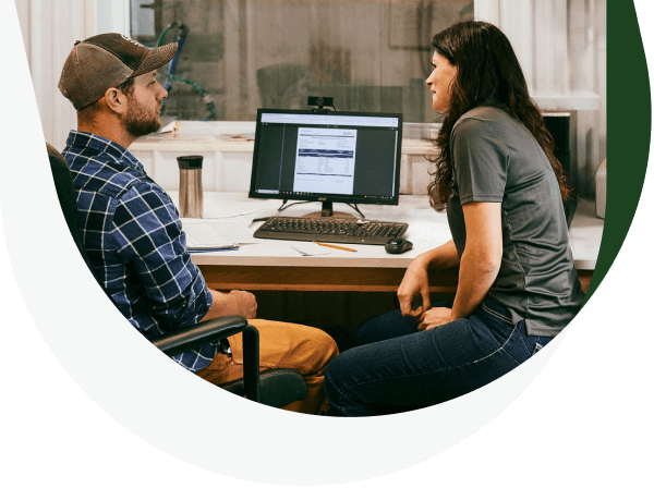 Two producers chat in their office.