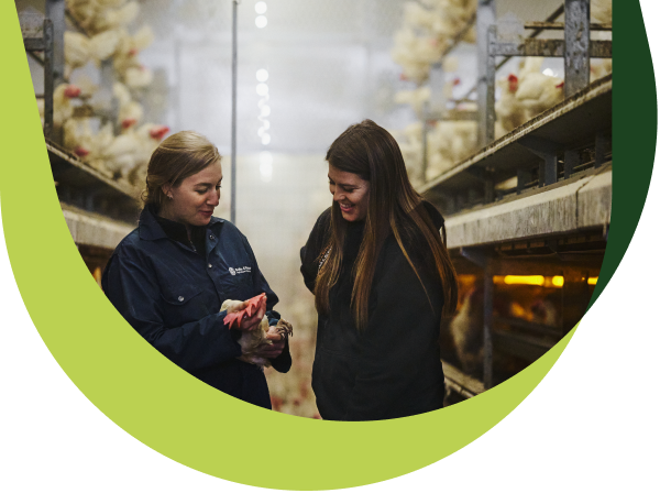 Two women in a henhouse