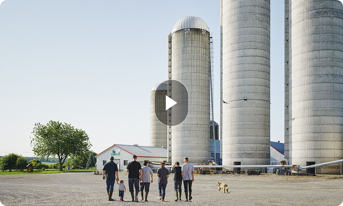 A family walks toward a farm.