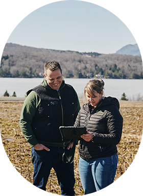 A producer and a agri-environmental agri-advisor are collecting in-field data on a tablet.