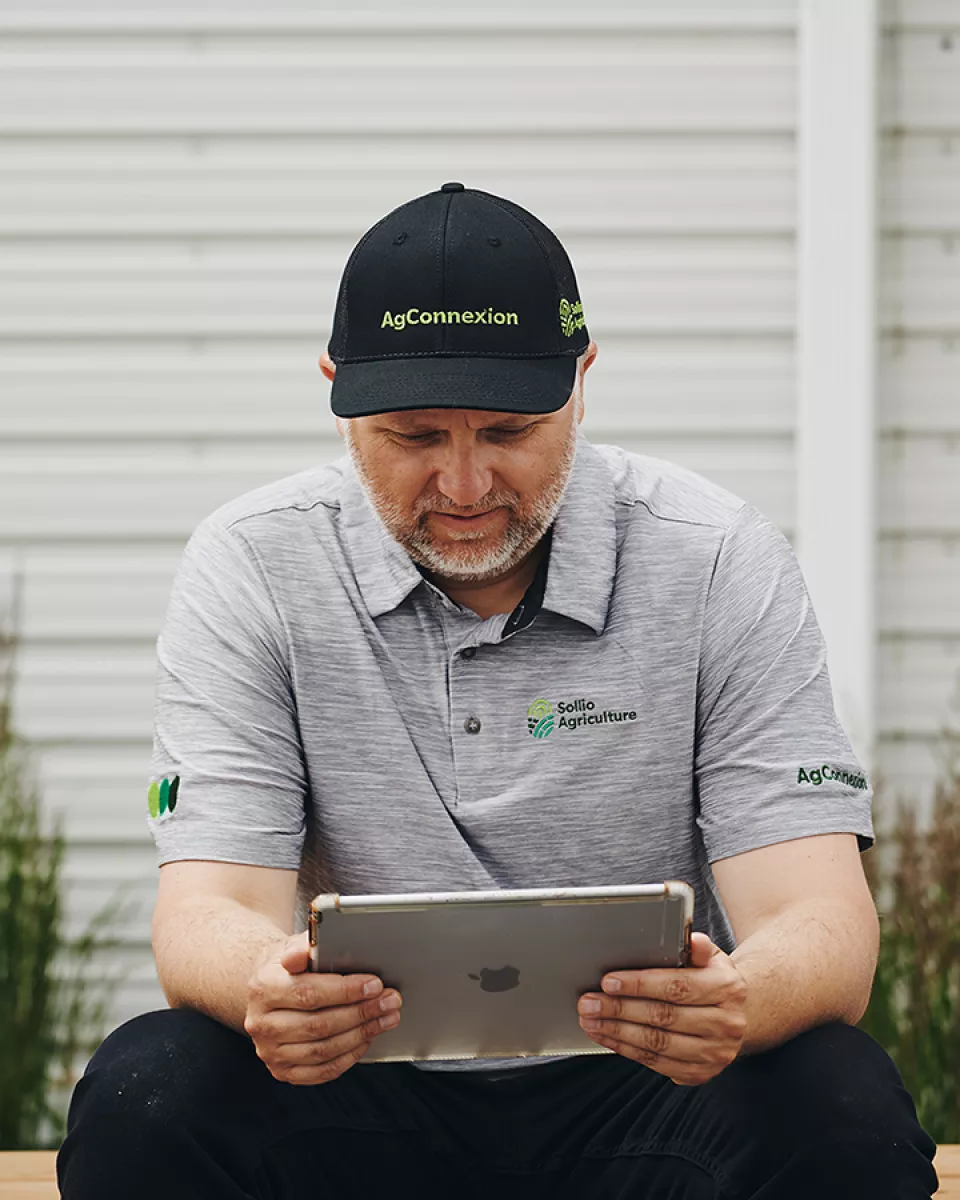 A man looks at his tablet.
